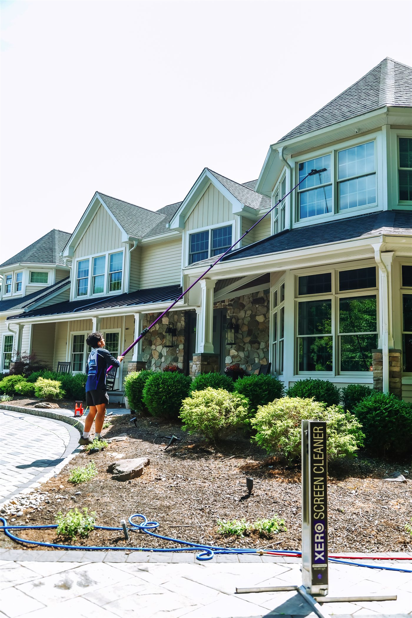 Pure Blue technician cleaning residential windows in North Jersey