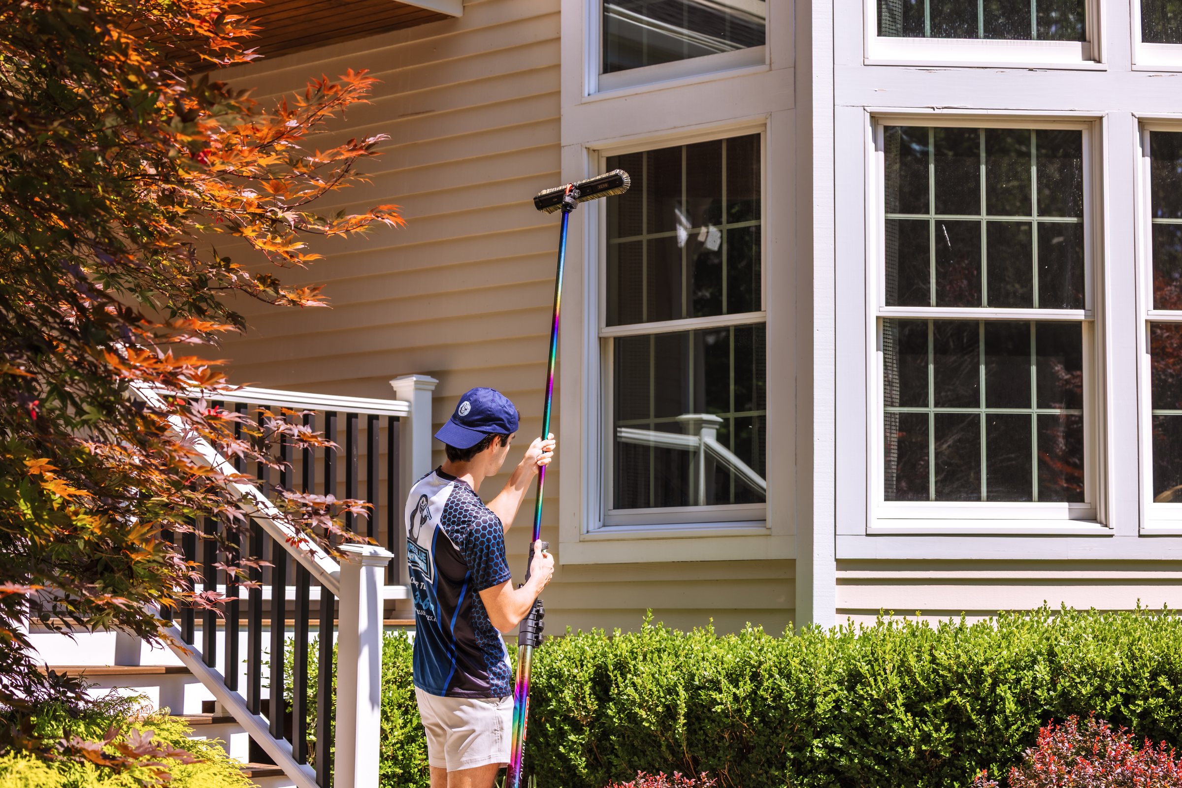 Pure Blue owner cleaning exterior windows